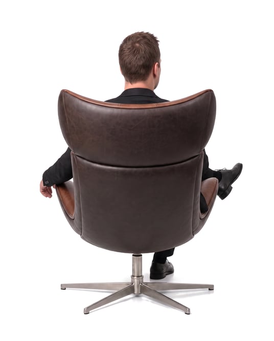 Oliver Goossens in a leather chair, seen from behind